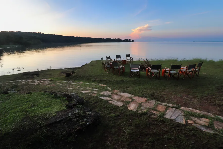 Campfire setting beside the lake at Walindi Point, used as Instagram carousel ad creative.